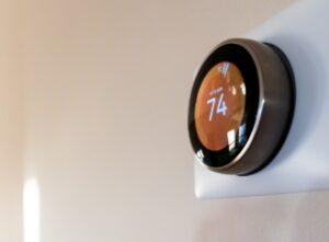 circular smart thermostat displays 74 degrees