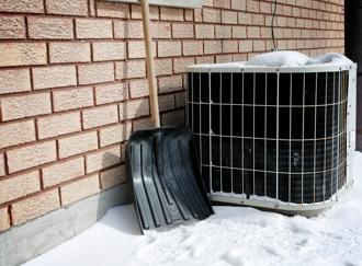 Old air conditioner and shovel in snow