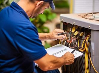 Efficient HVAC technician thoroughly inspecting a home air conditioning unit
