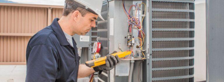 HVAC technician inspecting an air conditioning unit for electrical issues, including potential low voltage damage.