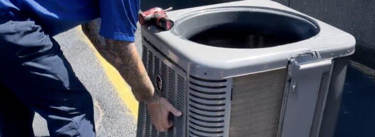 Technician performing HVAC maintenance on an outdoor unit in St. Louis