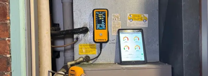 Professional HVAC diagnostic tools being used to measure air quality and system efficiency, demonstrating the advanced technology used by expert heating and cooling contractors.