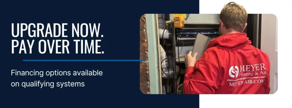 Meyer Heating & Air technician inspecting residential HVAC system while assisting homeowner with financing-eligible upgrade