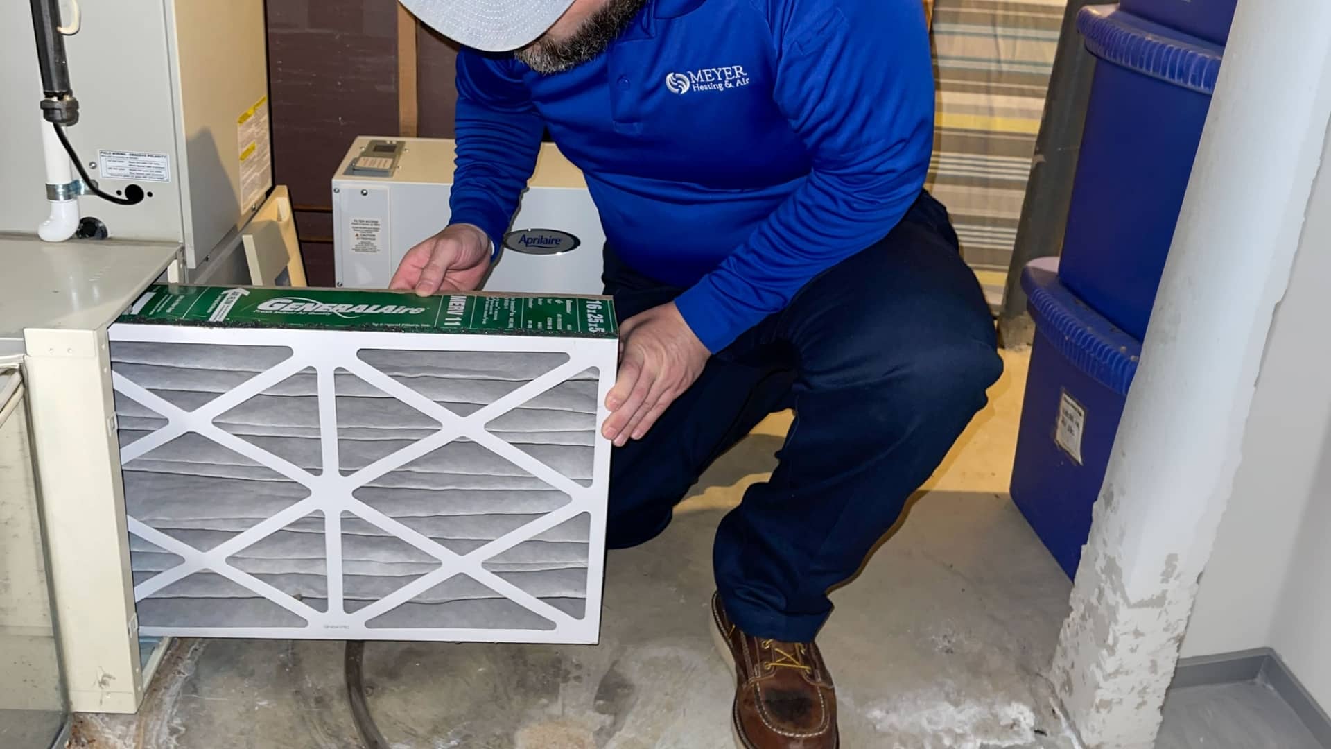 Meyer Heating & Air technician installing a pleated filter box