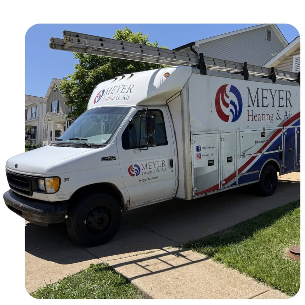 Meyer Heating & Air branded service van with roof rack parked curbside for a residential HVAC appointment.