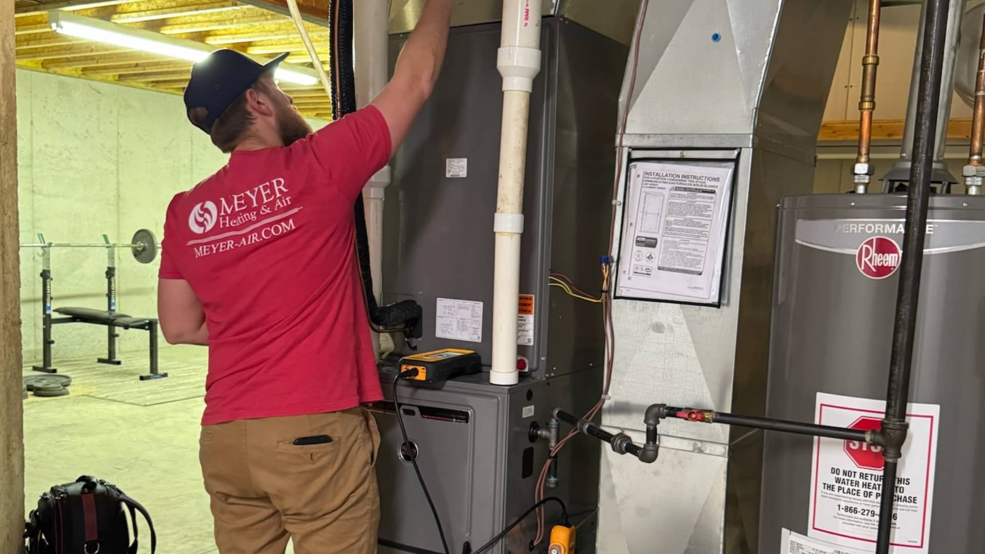 Meyer Heating & Air technician servicing a furnace